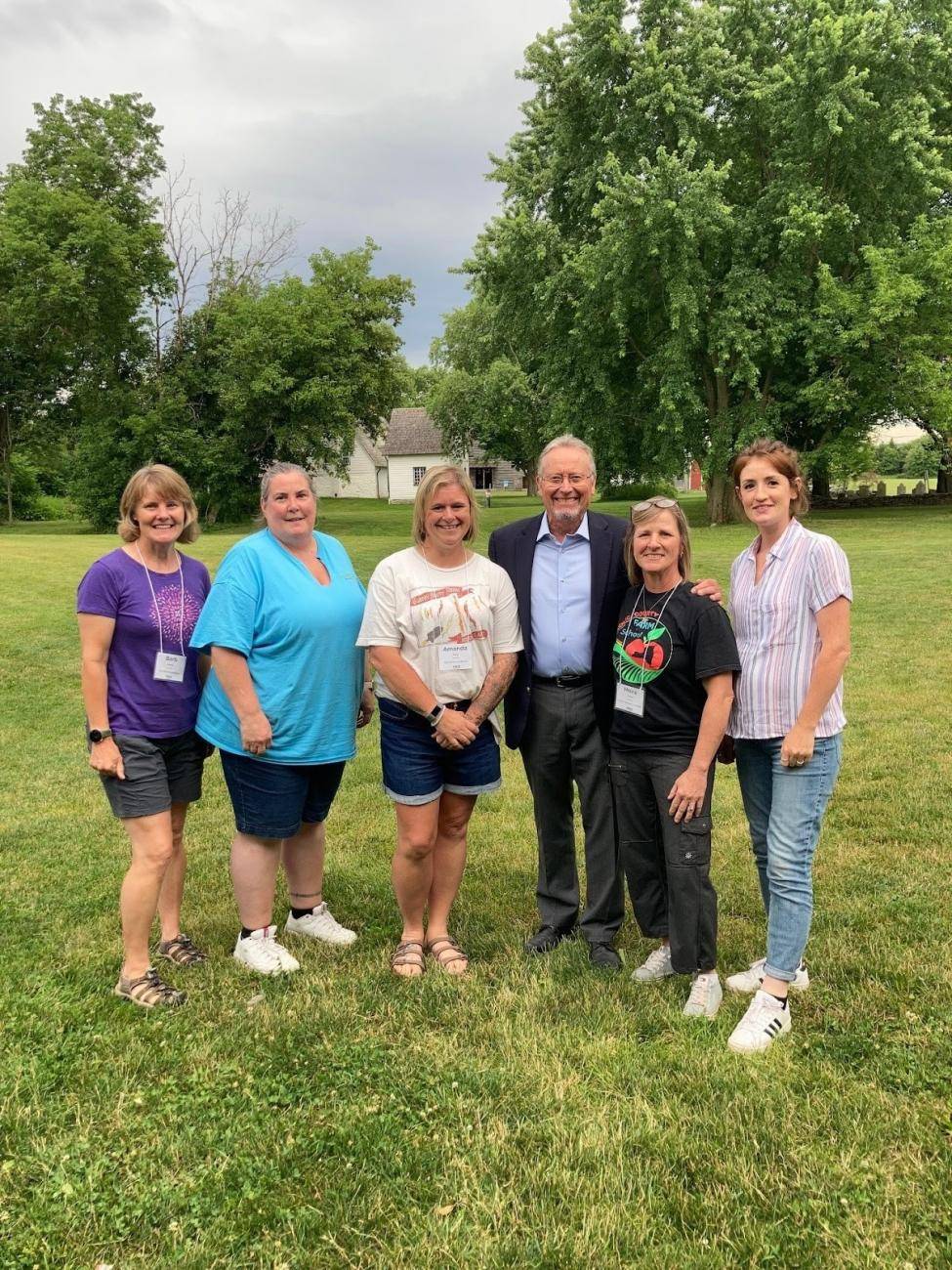 Members of the Mynderse Academy Farm to School Team pose for a photo with NYS Department of Agriculture and Markets Commissioner Richard Ball outside during the NY Farm to School Institute Summer Retreat