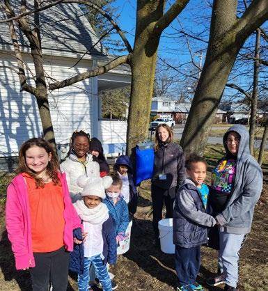 Students tapping a maple tree