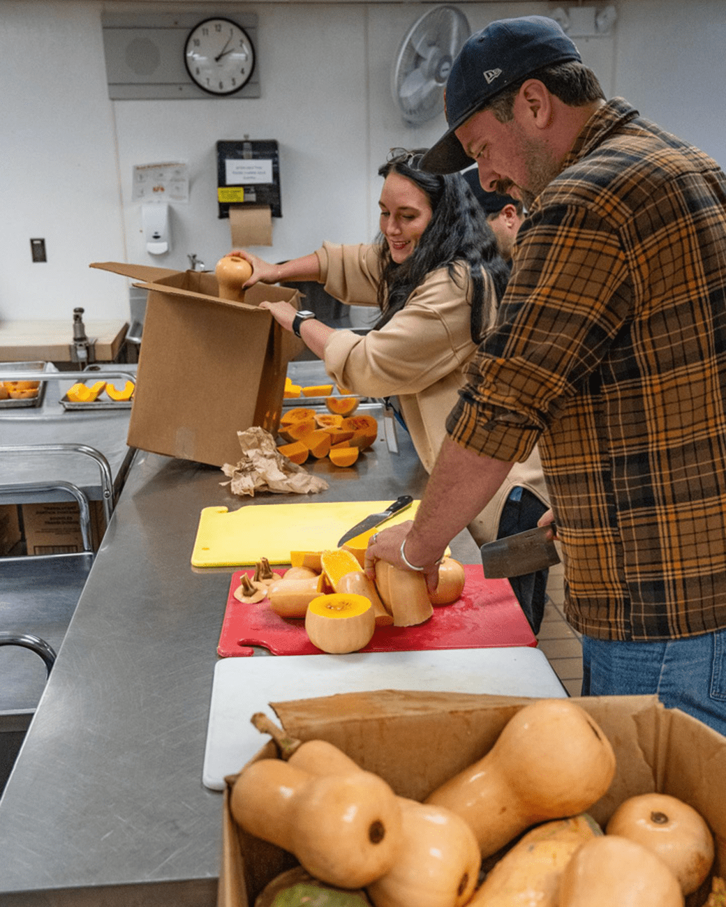 Butternut squash being cut by food service staff. 