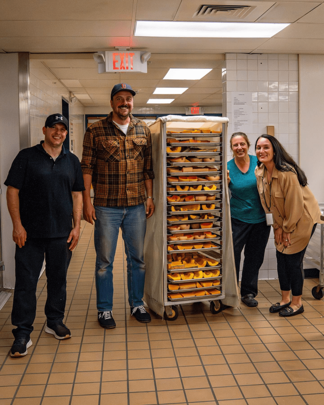 Shaker High Institute team by the racks of cut and cooked squash. 