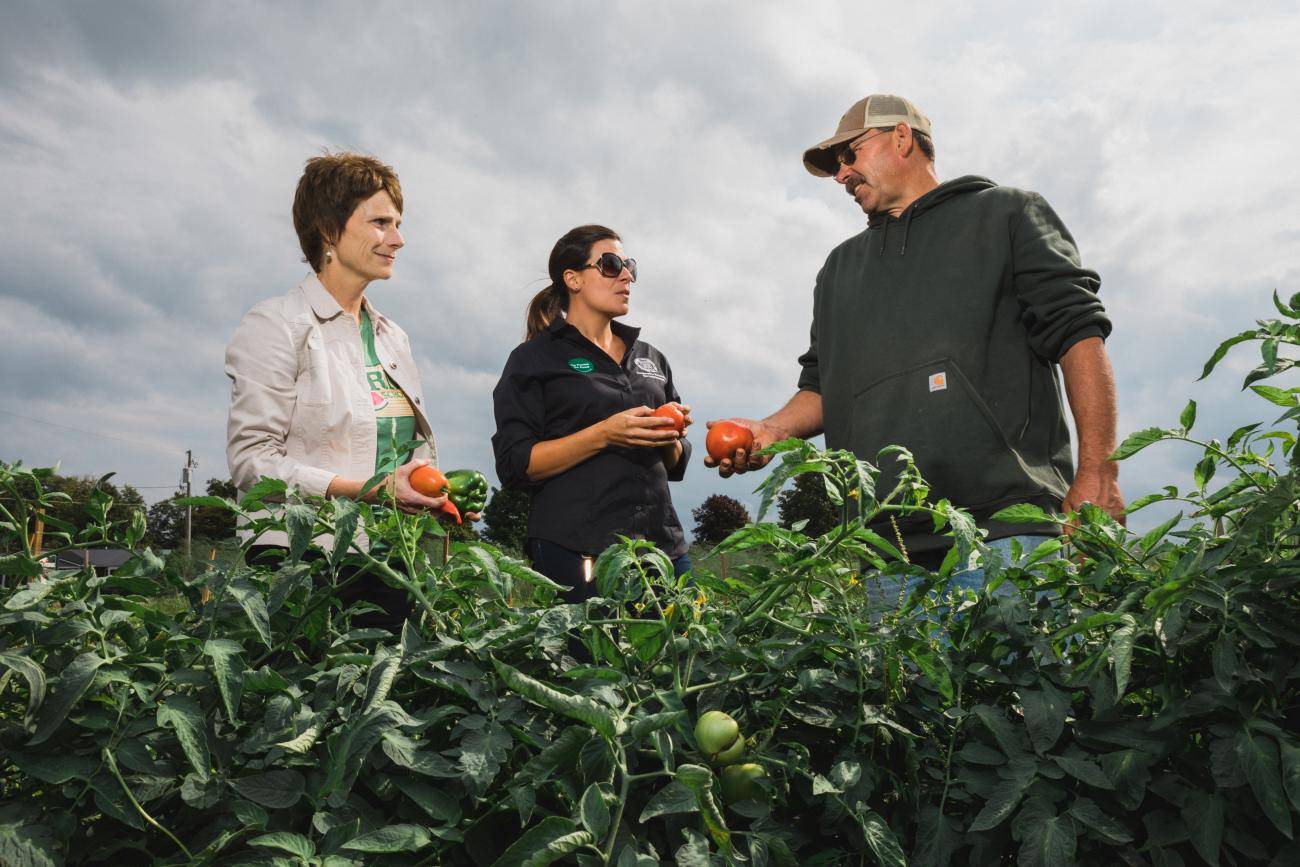food service director and farmer in field